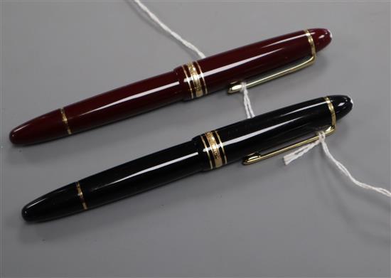 A Montblanc Meisterstuck burgundy fountain pen, 18K gold nib and a similar black-coloured pen